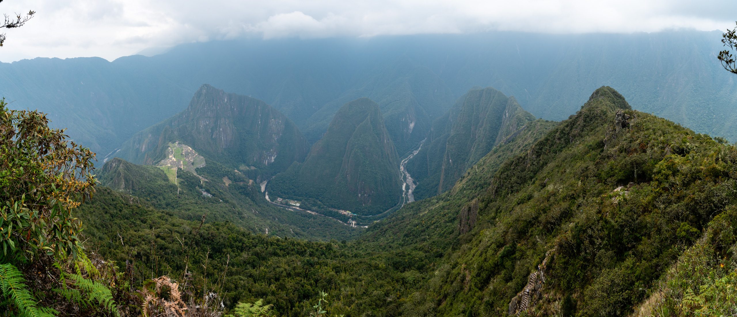 Machu Picchu (left), Huayna Picchu (behind Machu Picchu), the gravity-defying path to the top (bottom middle right).